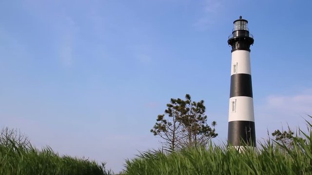 Looped footage features the black and white striped Bodie Island Lighthouse near Nags Head at Cape Hatteras National Seashore on the Outer Banks of North Carolina.