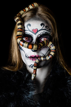 Beautiful portrait of a girl in makeupand milk snake, sugar skull, halloween   