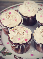 Chocolate cupcakes decorated with cream rose hearts toning