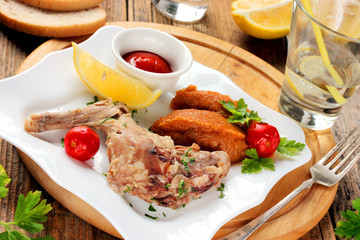 Boiled Rabbit with a garnish of vegetables and eggs with tomato sauce