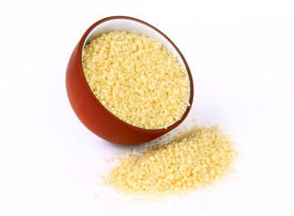 Raw couscous in bowl isolated