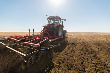 Tractor preparing land