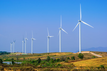 Wind turbine for electricity production on the mountains and beautiful sky.