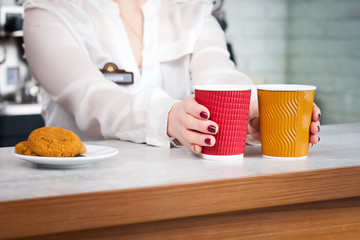 female barista and customers in a cafe