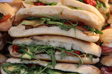 Ham and cheese salad sandwiches sliced at the market