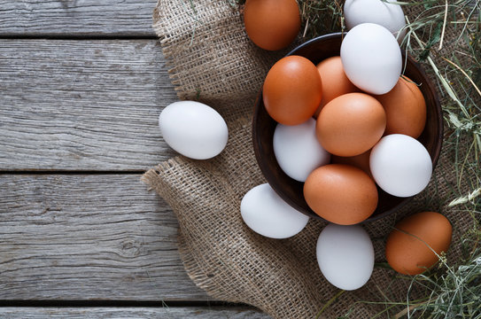 Fresh chicken brown eggs on sack, organic farming background