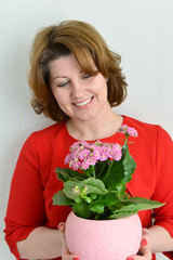 Woman holding kalanchoe in a pot