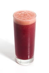 A glass of red healthy juice isolated over a white background
