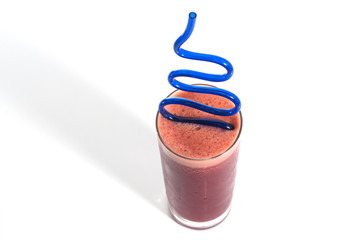 A glass of red healthy juice isolated over a white background