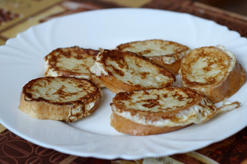 Toast with egg on a white plate