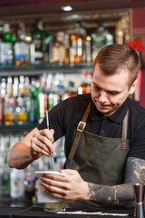 The bartender making cocktail