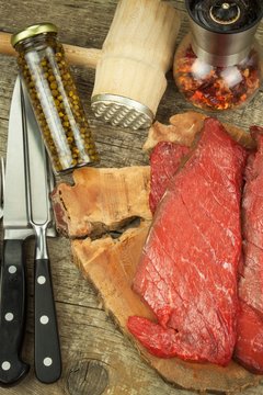 Preparing for grilling. Raw beef on a wooden board. Homework steak.