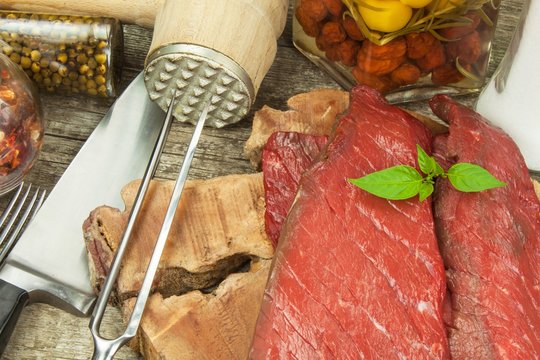 Preparing for grilling. Raw beef on a wooden board. Homework steak.