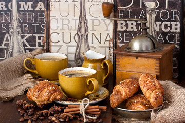 Composition with  coffee cups, croissant and old grinder