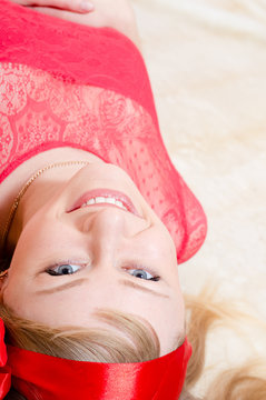 Portrait of a joyful young caucasian woman relaxing at home on light background, portrait closeup