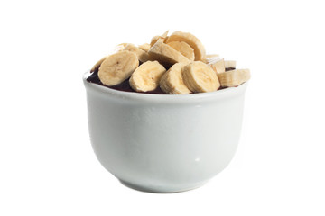 Acai cream with banana and strawberry in bowl isolated over white background.