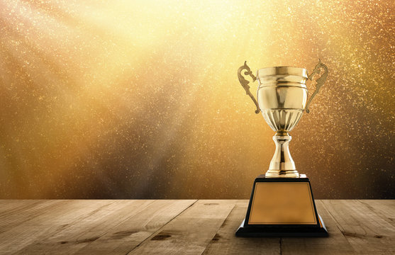 champion golden trophy on wood table with copy space and gold Twinkly  Lights and glitter stars light background copy space ready for your design.  Stock Photo | Adobe Stock