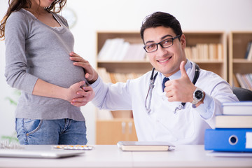 Fototapeta premium Pregnant woman visiting doctor for consultation