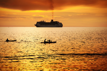 Naklejka premium Seascape with boat and colorful of sunset