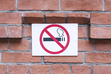 No smoking sign on brick wall. Smoking forbidden