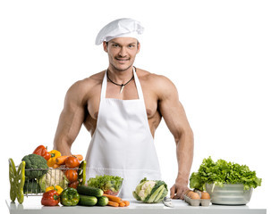 Man bodybuilder in white toque blanche and cook protective apron