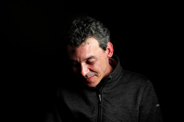 Obraz premium Portrait of stylish handsome midlle aged man smile on black background.Dressed well