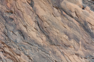 Textured surface of colorful rock