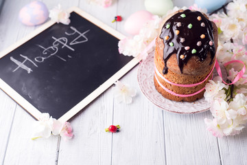 Fototapeta premium Easter cake with colored eggs and board for chalk