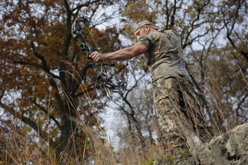 Bow hunter on a hill