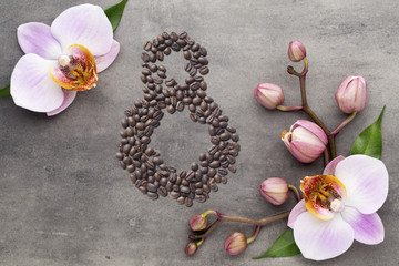 Coffee beans in form of number eight and orchids on beautifull background. International women's day. 8th march