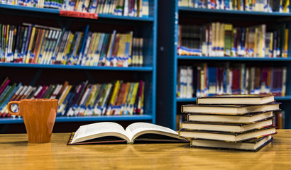 Open book on table in library
