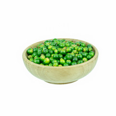 Fresh piper nigrum on bowl wood isolated on a white background