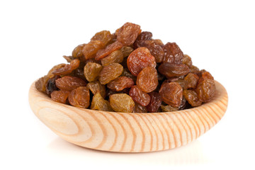 raisins in a wooden bowl isolated on white background