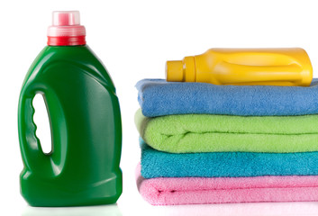 bottle laundry detergent and conditioner with towels isolated on white background
