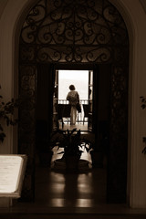 a women standing on a balcony in Ronda, Spain