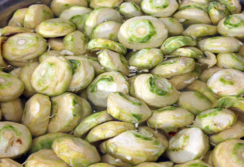 clean bottoms of artichokes prepared by the cook in the water
