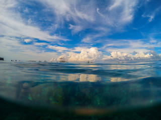 Marine landscape with transparent water and blue sky. Natural water background.