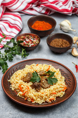 Pilaf with meat and vegetables with seasonings and spices. A popular dish of Asian cuisine