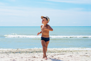 Fototapeta na wymiar A boy having fun on the beach.