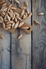 Almonds nuts on a rustic wooden background