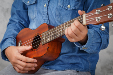 Fototapeta na wymiar A girl playing ukulele.