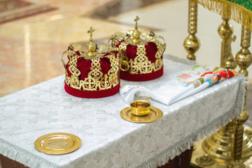 Indoors shot of two crowns on a table while ceremony