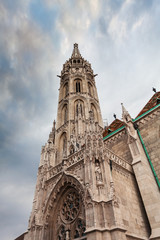 Fototapeta na wymiar St. Matthias Church in the Fisherman's Bastion in Budapest, Hungary. Cloudy weather, dramatic sky