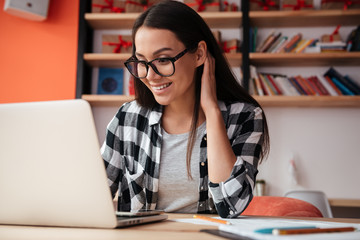 Pretty young caucasian woman using laptop computer.