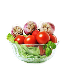 Onions, tomatos and lettuce in a glass bowl isolated on white background