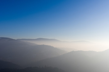 View from Yburg castle in direction mountain Hornisgrinde with fog in the valley