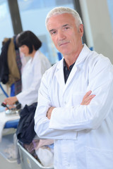 Portrait of senior man in white coat