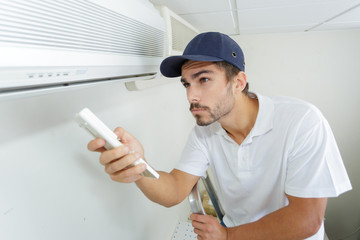 technician checking ac installation in clients building