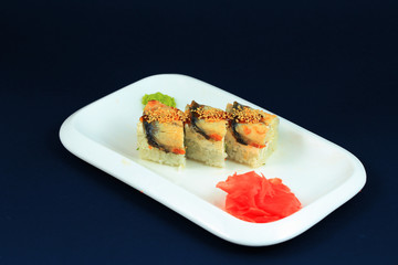 Sushi rolls on white plate.