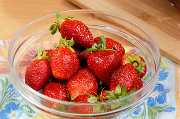 Fresh strawberry in a transparent salad bowl